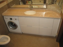 Bathroom countertop for washing machine and sink photo