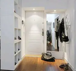 Hallway With A Mirror Opposite The Door Photo
