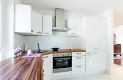 Glossy kitchen with wooden countertops in the interior