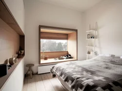 Bedroom design with a window along a long wall