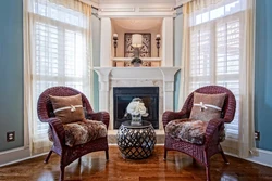 Armchairs in the interior of the living room with a fireplace