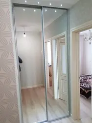 Built-in wardrobe in the hallway with one mirror photo