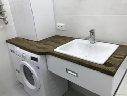 Design of a bathtub with a countertop under the sink in the bathroom