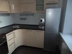 Kitchen in a five-story building with a refrigerator photo