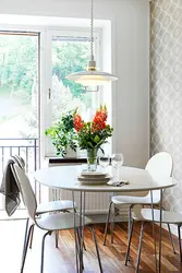 Photo of a kitchen with a round table against the wall