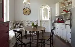 Photo of a kitchen with a round table against the wall