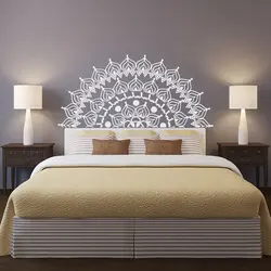 Photo of a bedroom with a flower above the bed