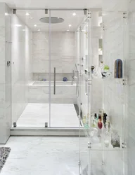 Photo of a bathroom with a shower behind glass