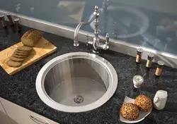 Kitchen with a round sink made of artificial stone photo