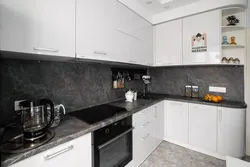 Gray kitchen with dark countertop and apron photo