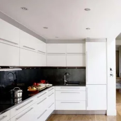 Photo of a kitchen with a white refrigerator