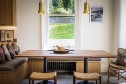 Kitchen design with sofa and table by the window