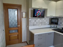 Photo of a small kitchen with a TV