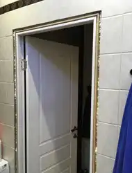 Photo of a bathroom door without trim