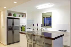 Refrigerator in a niche in the interior of the kitchen