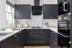 Photo of a kitchen with black handles