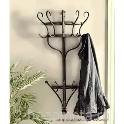 Metal wall hangers for clothes in the hallway photo