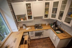 Corner kitchen design with countertop by the window