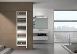 White heated towel rail for bathroom photo