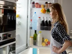 Open refrigerator in the kitchen photo