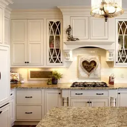 Photo of a beige kitchen with a hood