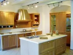 Photo of a beige kitchen with a hood