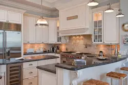 Photo of a beige kitchen with a hood