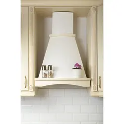 Photo of a beige kitchen with a hood