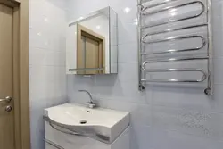 Photo of a heated towel rail in a small bathroom