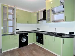 Green kitchen with black countertop photo