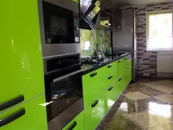 Green kitchen with black countertop photo