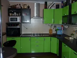 Green kitchen with black countertop photo