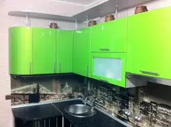 Green kitchen with black countertop photo