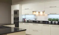 Black handles on a beige kitchen photo