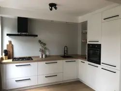 Black handles on a beige kitchen photo