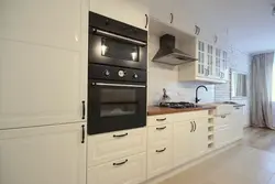Black handles on a beige kitchen photo