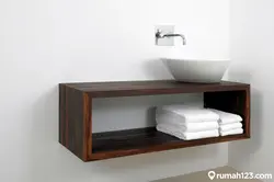 Shelf under the sink in the bathroom photo