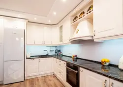 Black appliances in a beige kitchen photo