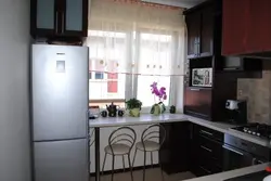 Refrigerator closes the window in the kitchen photo