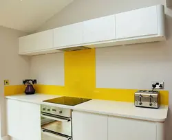 Белая кухня с желтым фартуком фото