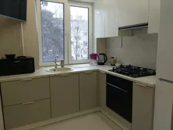 Corner kitchen refrigerator by the window photo