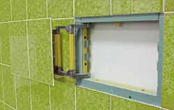 Hatch under the bathtub under the tiles photo