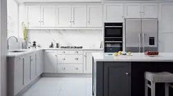 Photo of white kitchen with gray appliances