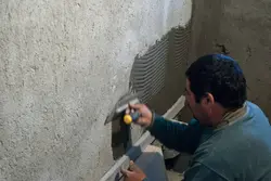 Plaster under tiles in the bathroom photo