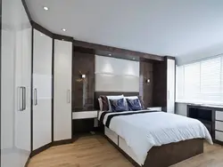 Wardrobe behind the bed in the bedroom photo