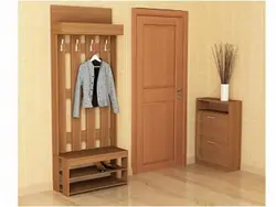 Coat rack in a small hallway with a mirror photo