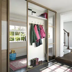 Narrow wardrobe in the hallway with a mirror photo