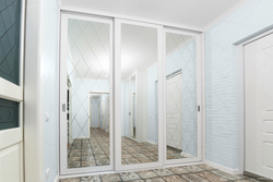 White hallway wardrobe with mirror photo