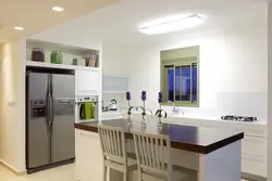 Refrigerator in a niche in the kitchen interior photo