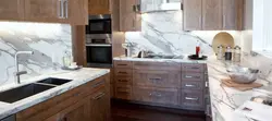 Marble apron and wooden countertop in the kitchen photo